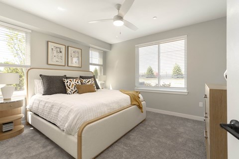 a bedroom with a bed and a ceiling fan